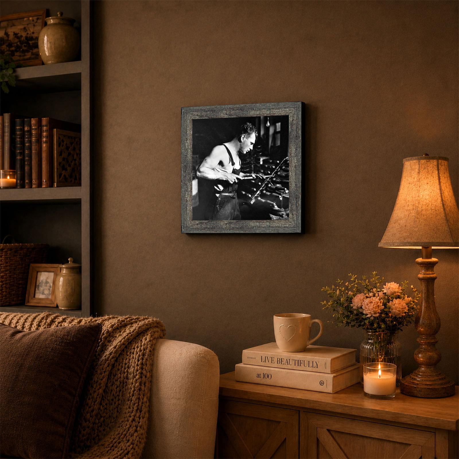 Man in factory framed wall art displayed in a man cave