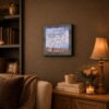 Love Is Never Lost framed print displayed on a living room shelf