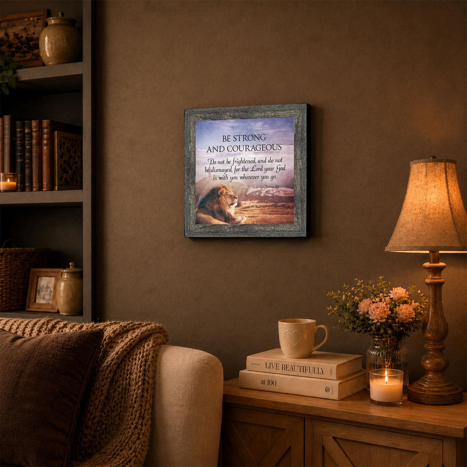 Be Strong and Courageous lion framed wall art displayed in a living room